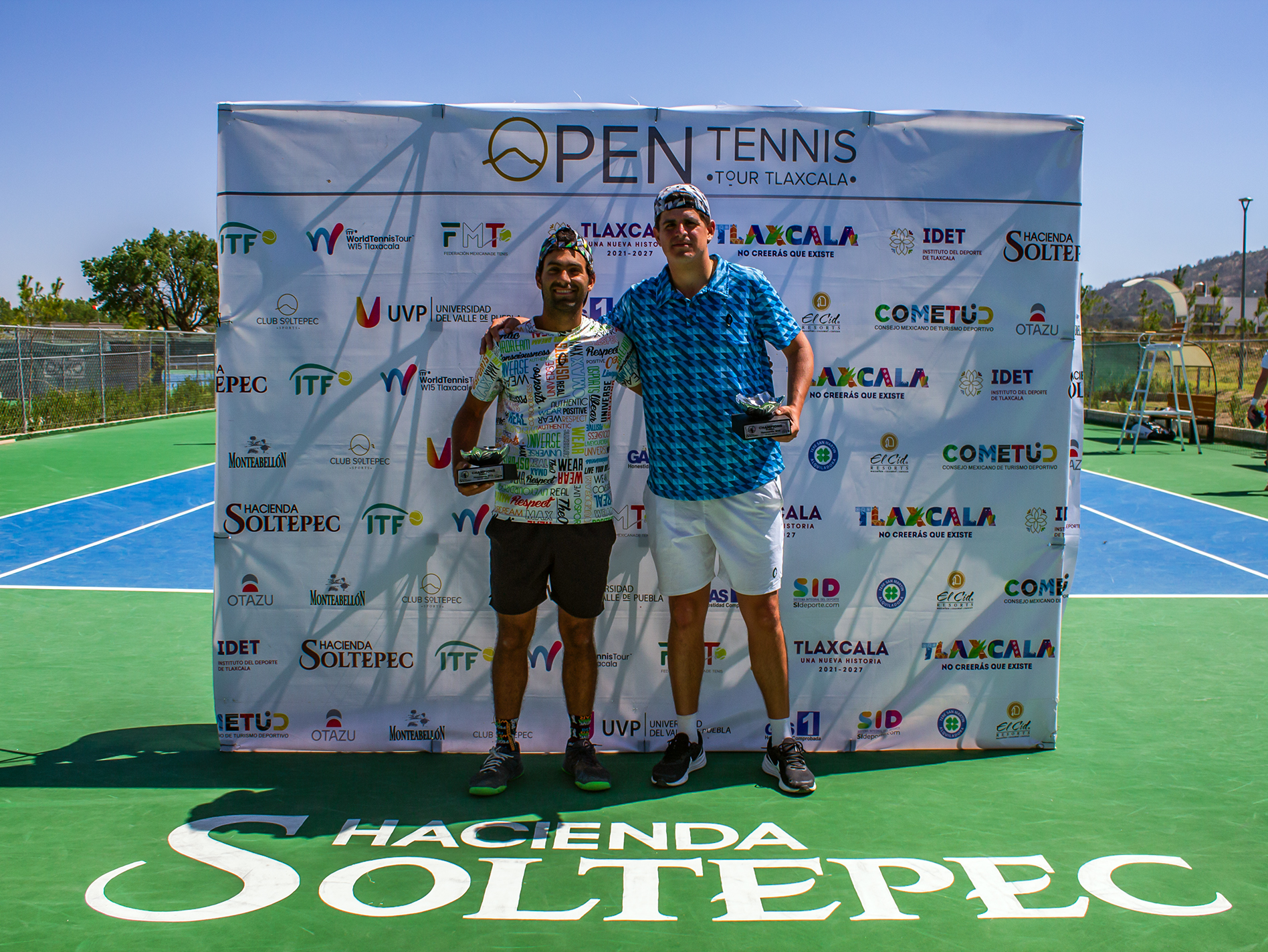Daniel Moreno with the doubles champions trophy at an ITF World Tennis Tour event